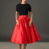 Woman wearing The Grace red satin full circle midi skirt with matching belt and pockets