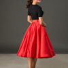 Woman wearing The Grace red satin full circle midi skirt with matching belt and pockets