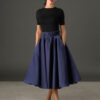 Woman wearing The Grace navy satin full circle midi skirt with matching belt and pockets