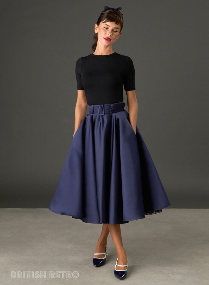 Woman wearing The Grace navy satin full circle midi skirt with matching belt and pockets