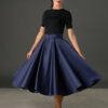 Woman wearing The Grace navy satin full circle midi skirt with matching belt and pockets