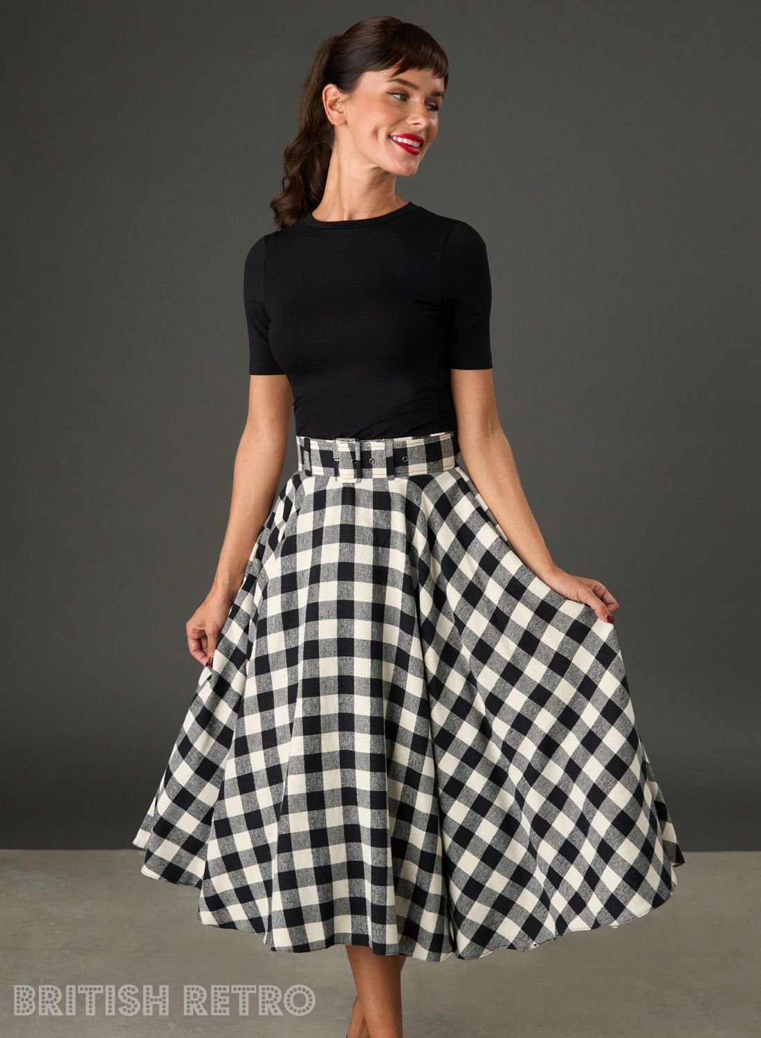 Woman wearing The Eloise black and white gingham full circle midi skirt with matching belt
